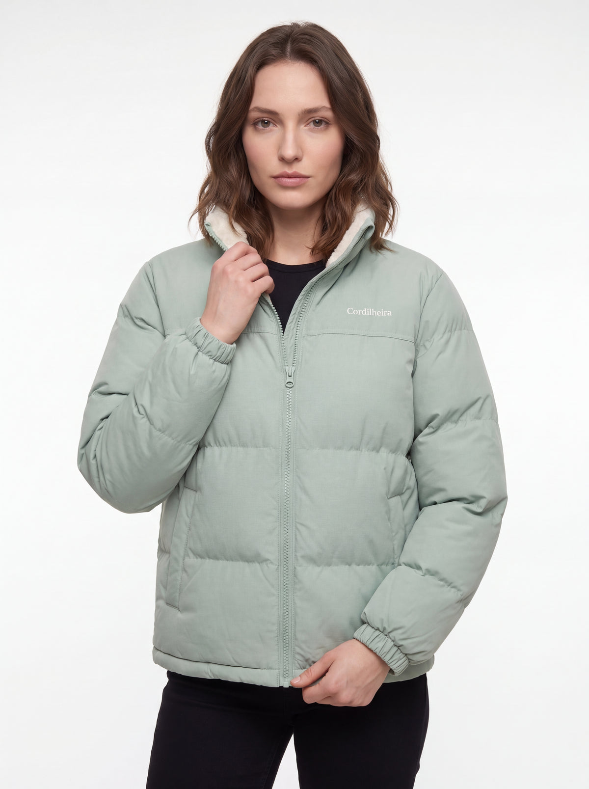 Modelo posando com Jaqueta Puffer FrostLayer Dupla Face Feminina, Roupa da Marca Cordilheira com Boa qualidade e proteção Confiável para inverno outdoor.