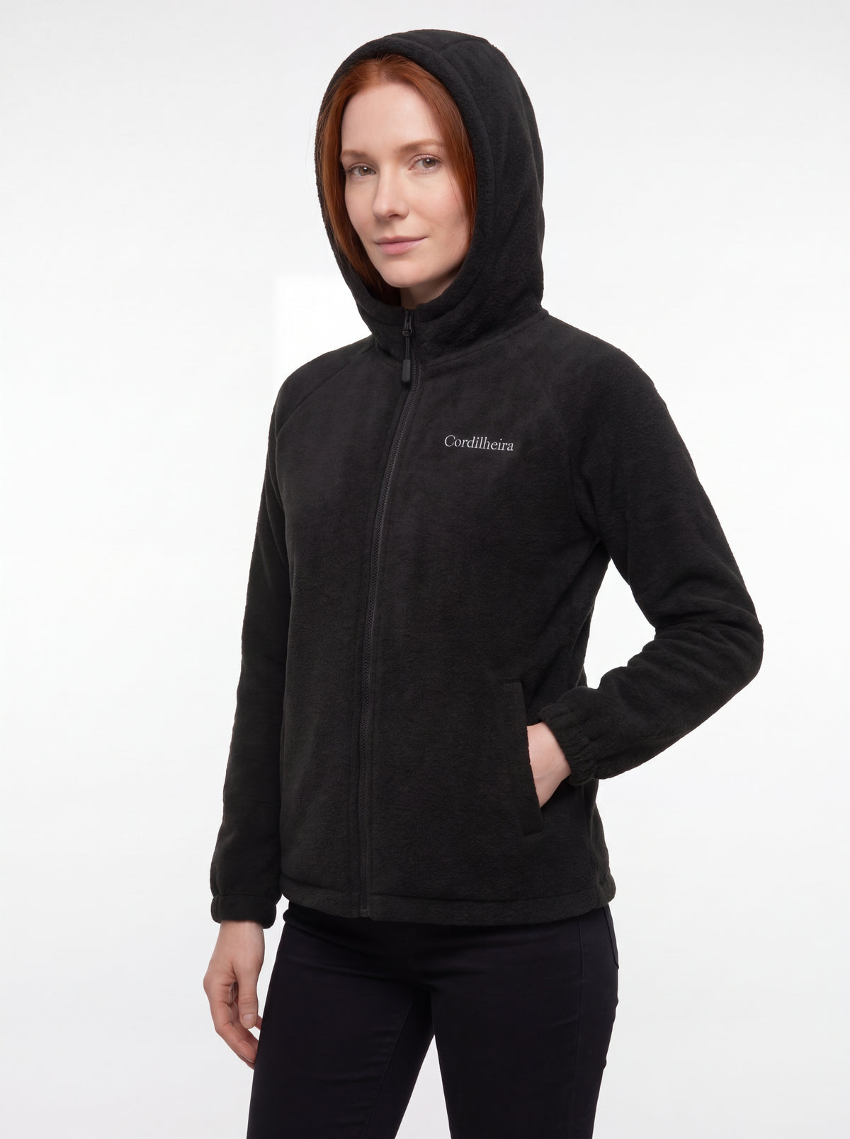 Modelo posando com Jaqueta Cordilheira Fleece Hooded Feminina, Roupa da Marca Cordilheira com Boa qualidade, resistência e conforto Confiável para dias frios e uso ao ar livre.